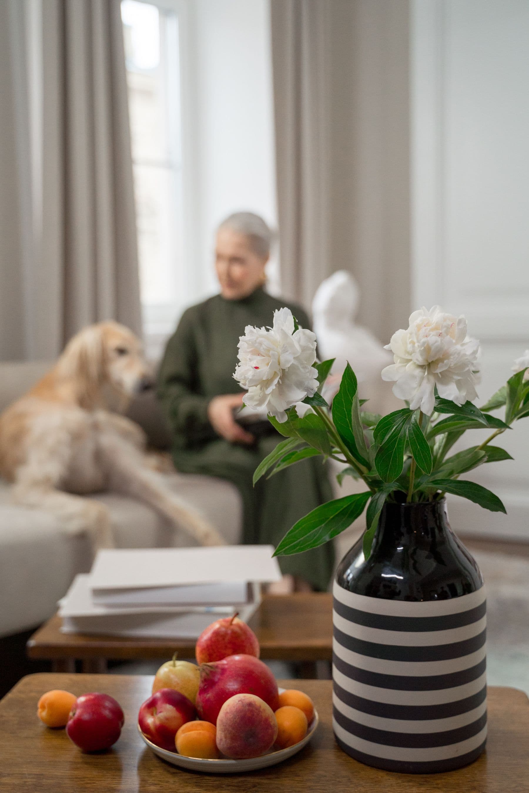 An older woman and her dog sharing a quiet moment at home.